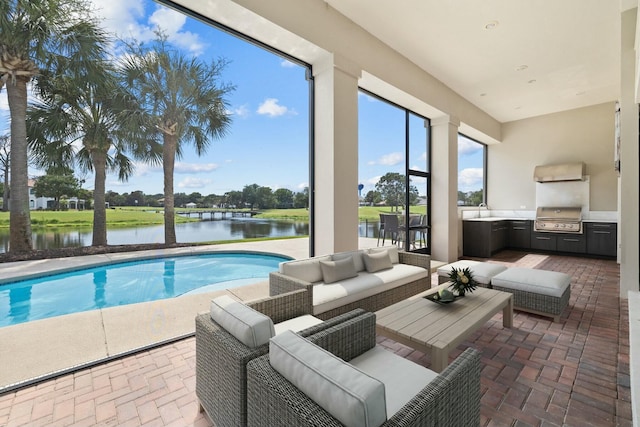 view of pool with a water view, area for grilling, and sink