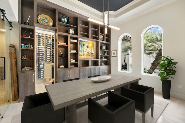 dining space with crown molding and a raised ceiling