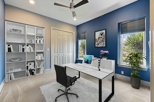 office featuring a wealth of natural light, light colored carpet, and ceiling fan