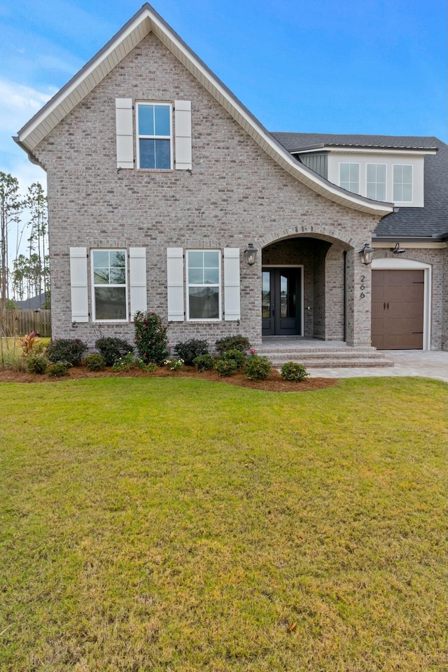 view of front of house with a front yard and a garage