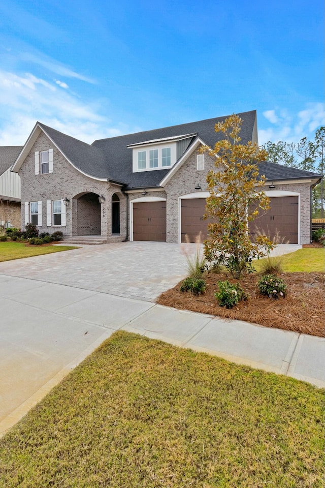 view of front of property featuring a garage and a front lawn