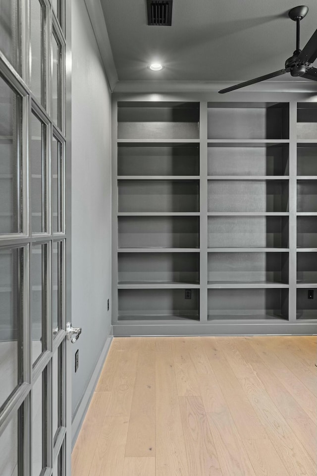 interior space with wood-type flooring and ceiling fan