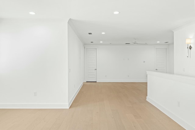 empty room featuring light hardwood / wood-style flooring and crown molding