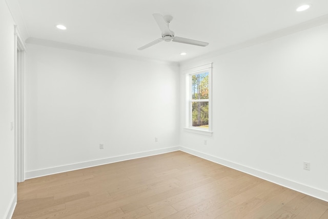 spare room with light wood-type flooring, ceiling fan, and ornamental molding