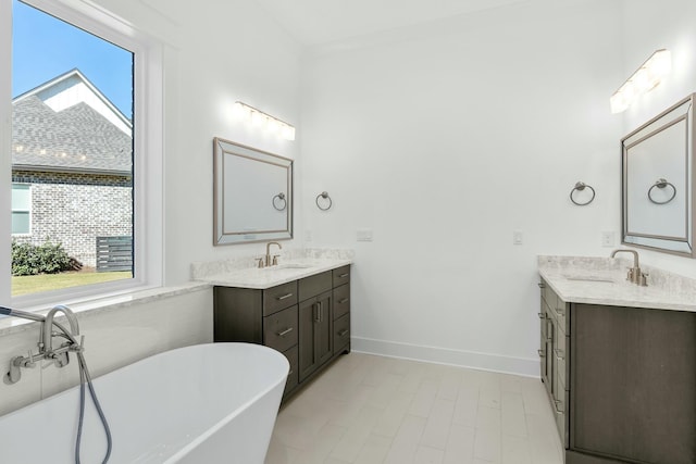 bathroom with vanity, a tub to relax in, and a wealth of natural light