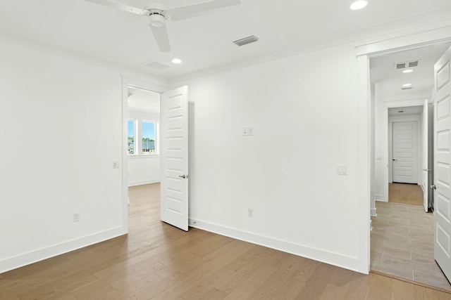 empty room with light hardwood / wood-style flooring, ceiling fan, and ornamental molding