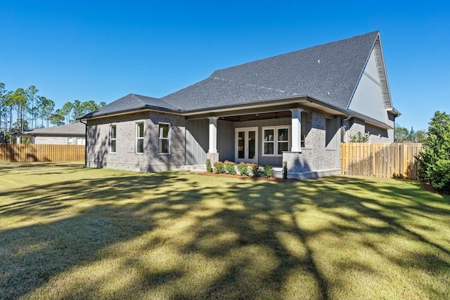 rear view of property featuring a yard