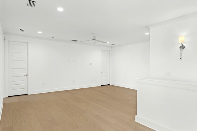 spare room with light hardwood / wood-style flooring and ceiling fan