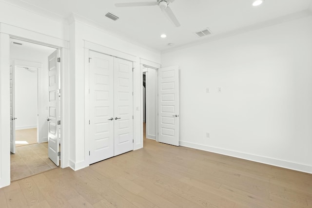 unfurnished bedroom with ceiling fan, light hardwood / wood-style floors, ornamental molding, and a closet