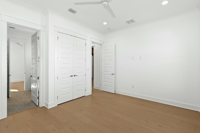 unfurnished bedroom with hardwood / wood-style flooring, ceiling fan, and crown molding