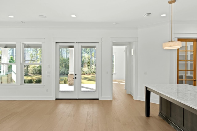 doorway featuring french doors, light hardwood / wood-style floors, and crown molding