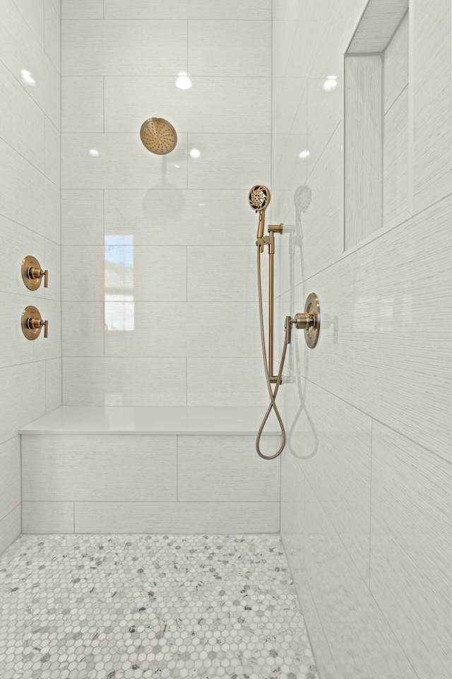 bathroom with a tile shower