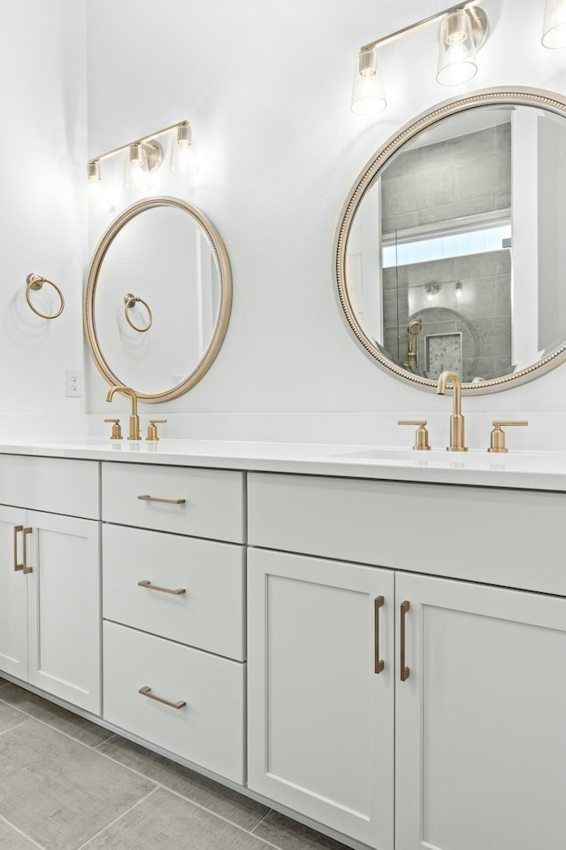 bathroom featuring tile patterned floors, vanity, and a shower with door