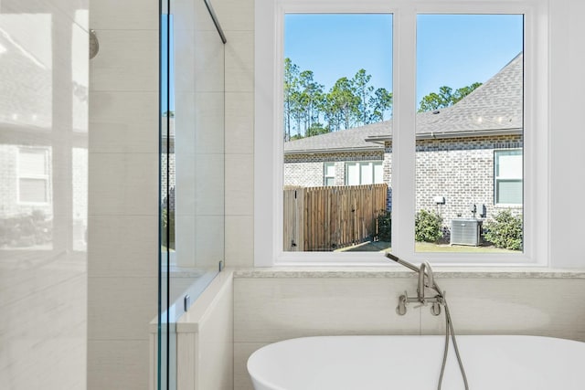 bathroom with a tub to relax in