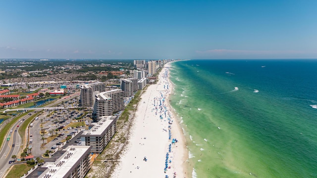 drone / aerial view featuring a water view and a beach view