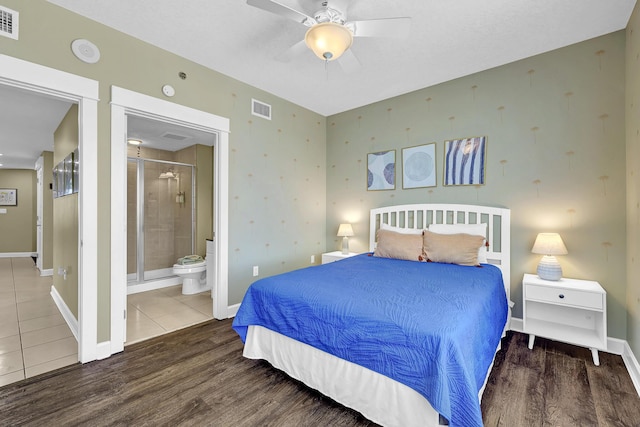 bedroom with tile patterned floors, ceiling fan, and ensuite bathroom