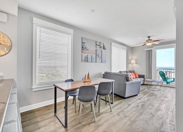 dining area featuring light hardwood / wood-style flooring and ceiling fan