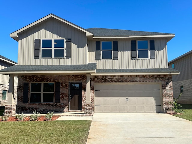 view of front of home featuring a front yard and a garage