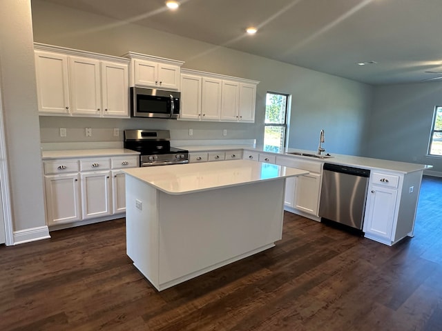 kitchen with white cabinets, sink, kitchen peninsula, and stainless steel appliances