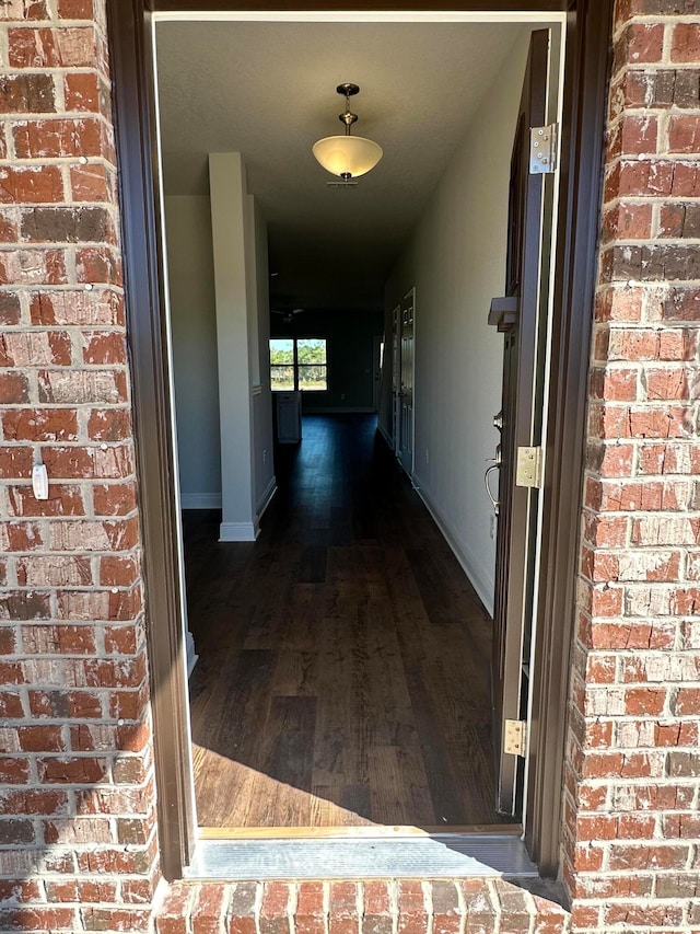 hallway featuring dark wood-type flooring