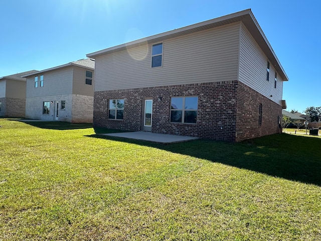 back of house featuring a yard and a patio