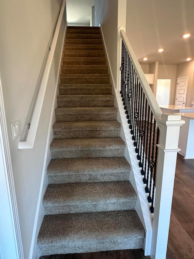 stairway featuring hardwood / wood-style floors