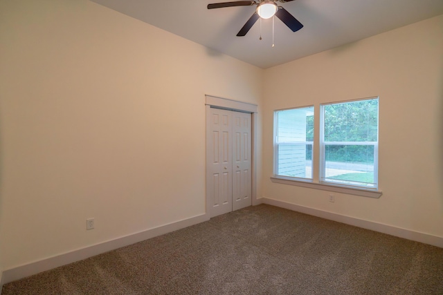 unfurnished room featuring ceiling fan and carpet floors