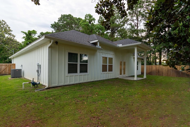 back of house featuring a lawn, central air condition unit, and french doors