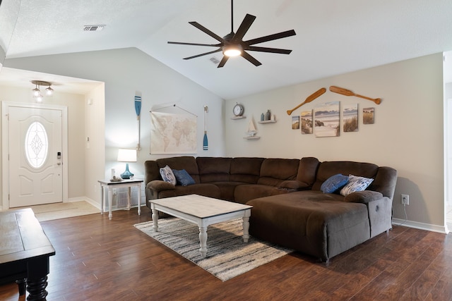 living room with dark hardwood / wood-style floors, ceiling fan, and lofted ceiling