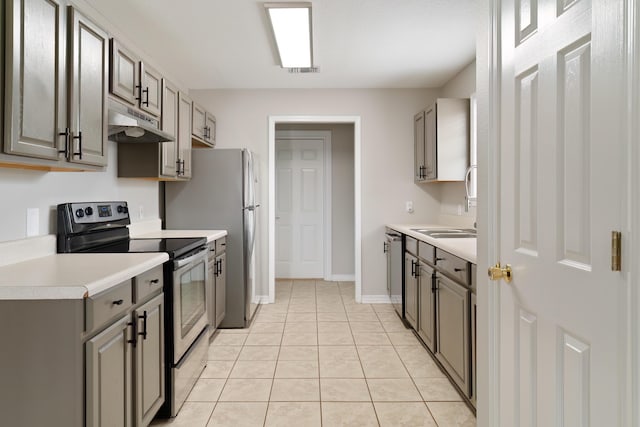 kitchen with gray cabinetry, light tile patterned floors, sink, and appliances with stainless steel finishes