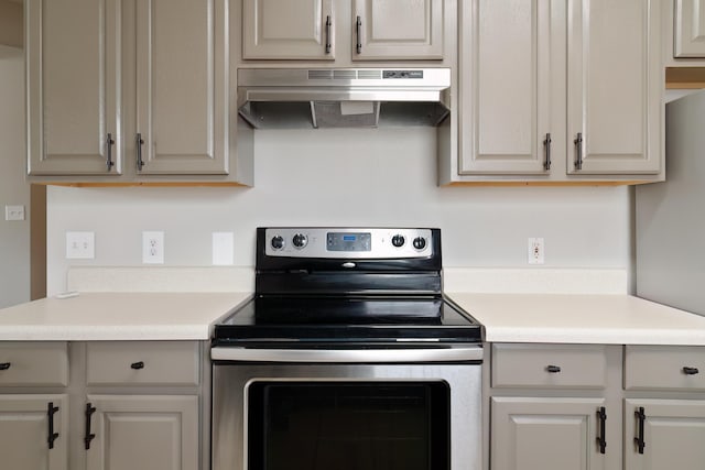 kitchen with stainless steel electric stove and exhaust hood