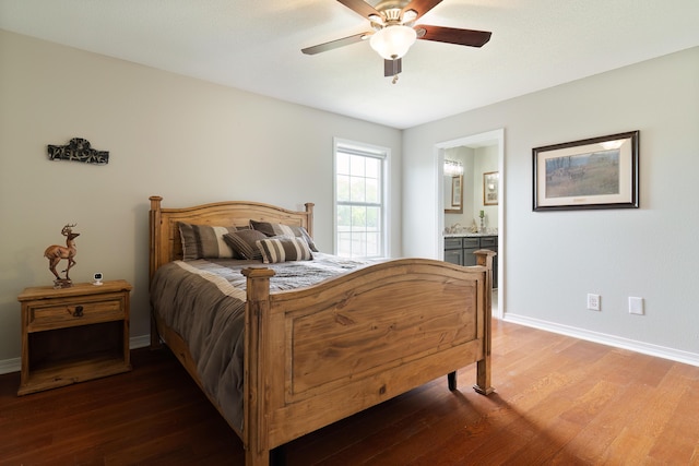 bedroom with ensuite bath, ceiling fan, and dark wood-type flooring