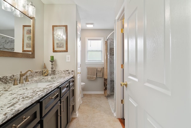 bathroom with a shower with shower curtain, vanity, toilet, and tile patterned flooring