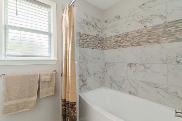 bathroom with plenty of natural light and shower / bathtub combination with curtain