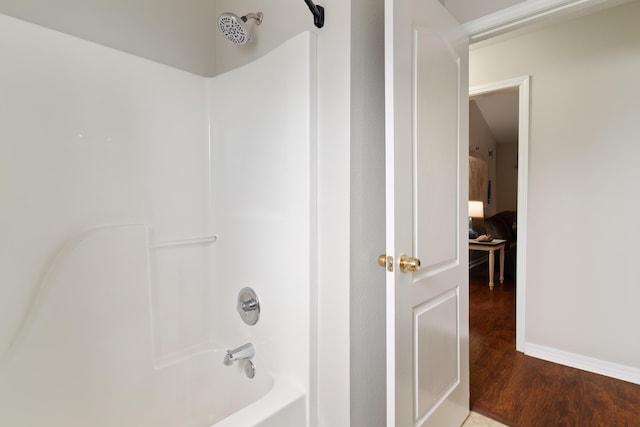 bathroom with shower / bathing tub combination and wood-type flooring