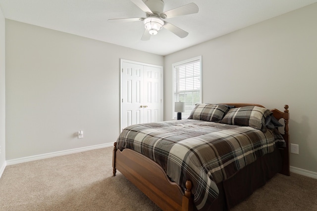 bedroom featuring ceiling fan, a closet, and carpet