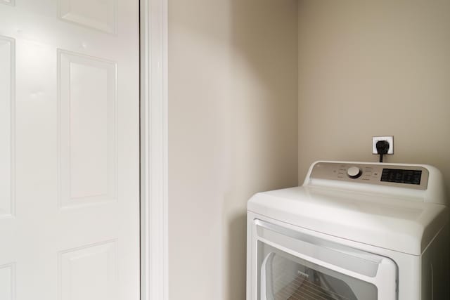 clothes washing area featuring washer / dryer