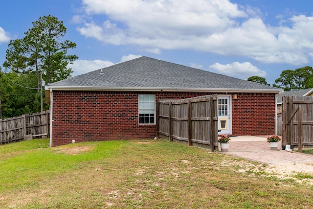 back of property featuring a yard