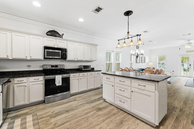 kitchen featuring light hardwood / wood-style flooring, hanging light fixtures, stainless steel appliances, white cabinetry, and ceiling fan with notable chandelier