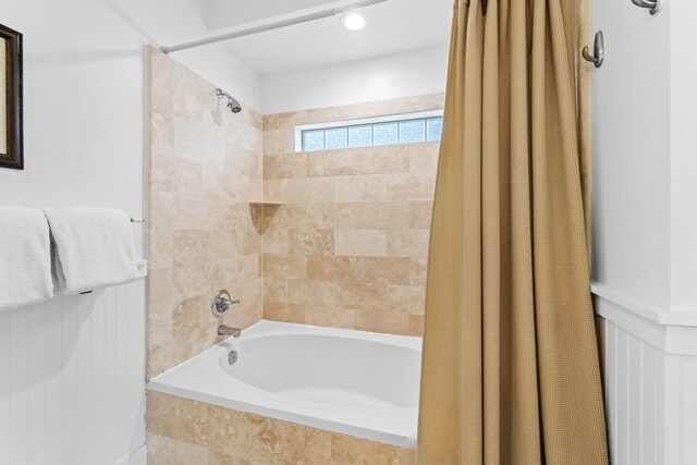 bathroom with shower / bath combo with shower curtain