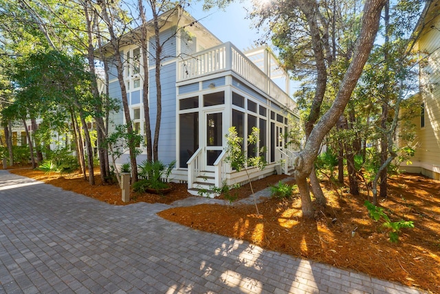 exterior space featuring a balcony and a sunroom