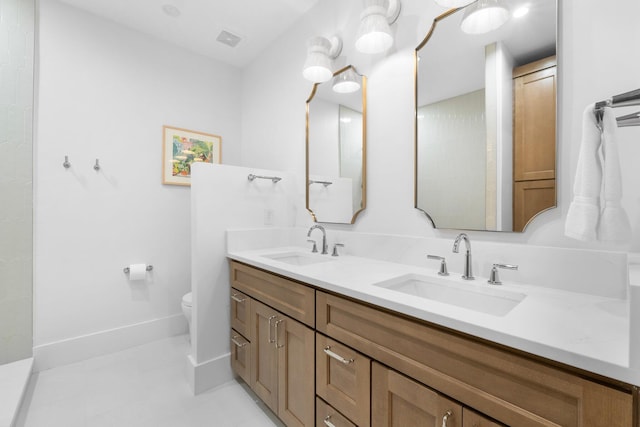 bathroom featuring toilet and vanity