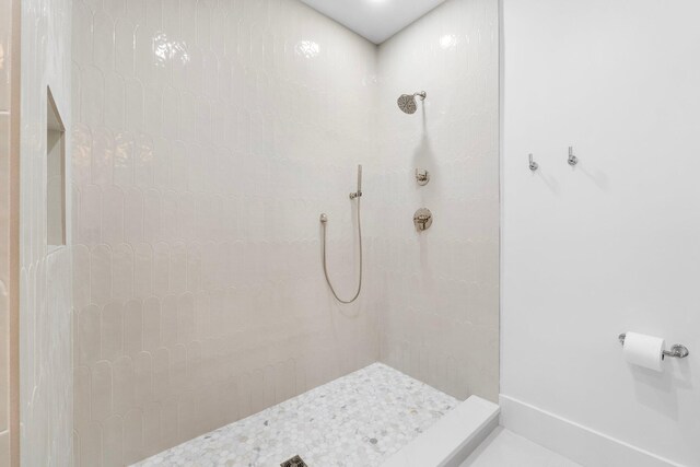 bathroom with a tile shower