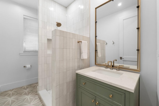 bathroom with a shower, vanity, and tile patterned floors