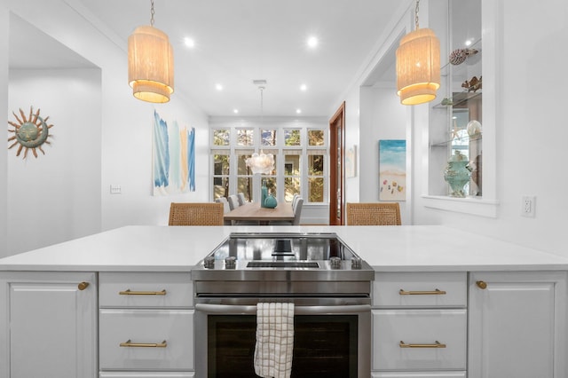 kitchen featuring decorative light fixtures, kitchen peninsula, stainless steel electric stove, and white cabinetry