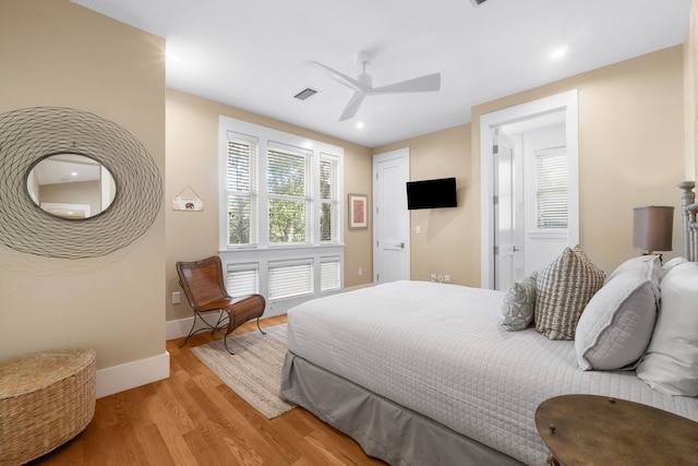 bedroom with ceiling fan and light wood-type flooring