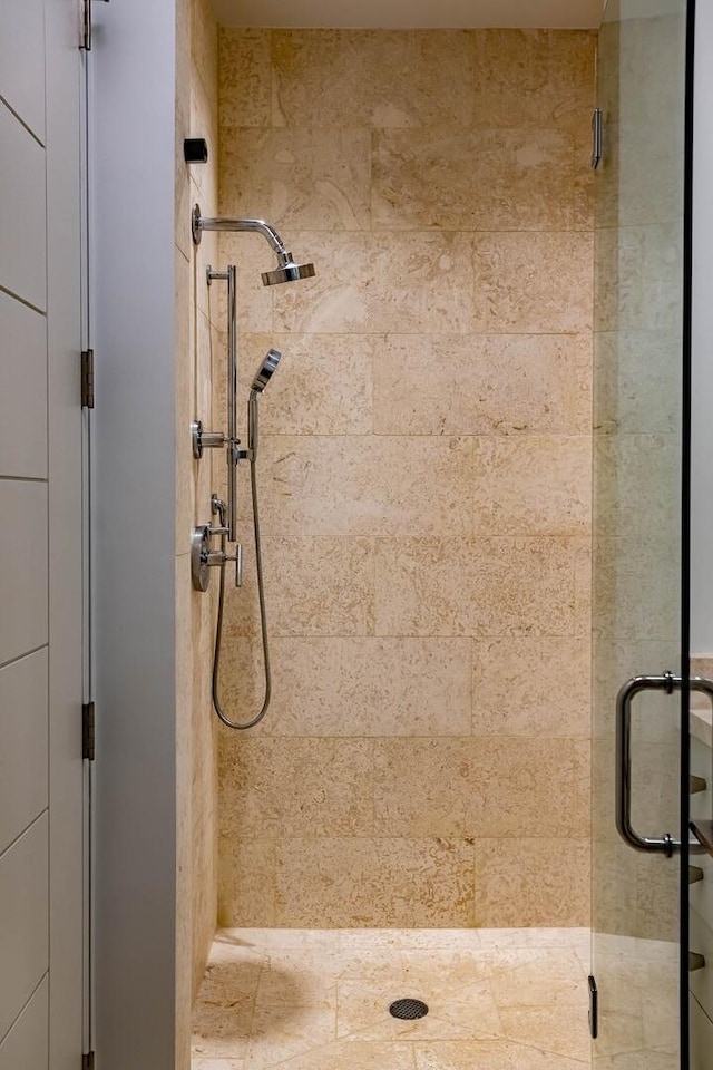 bathroom featuring a shower with door