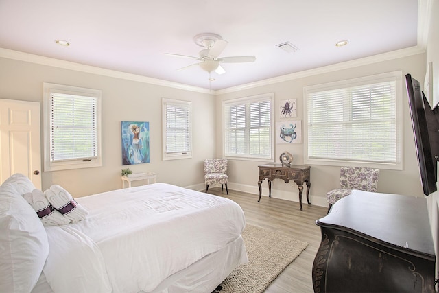 bedroom with ceiling fan, crown molding, and light hardwood / wood-style floors