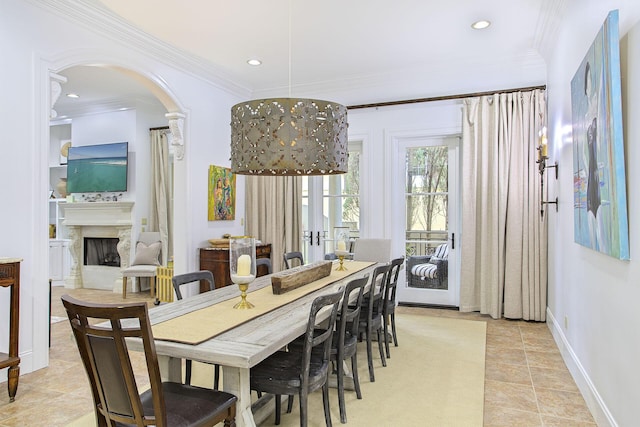 dining area featuring ornamental molding, light tile patterned flooring, and an inviting chandelier