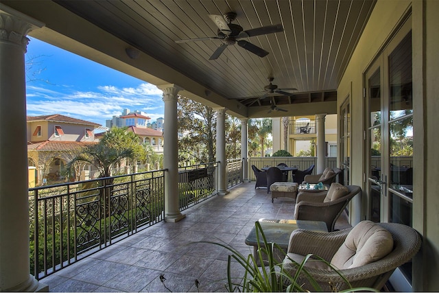 exterior space with ceiling fan and a balcony